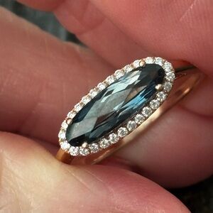 14k rose gold ring with London blue topaz and natural diamond halo.